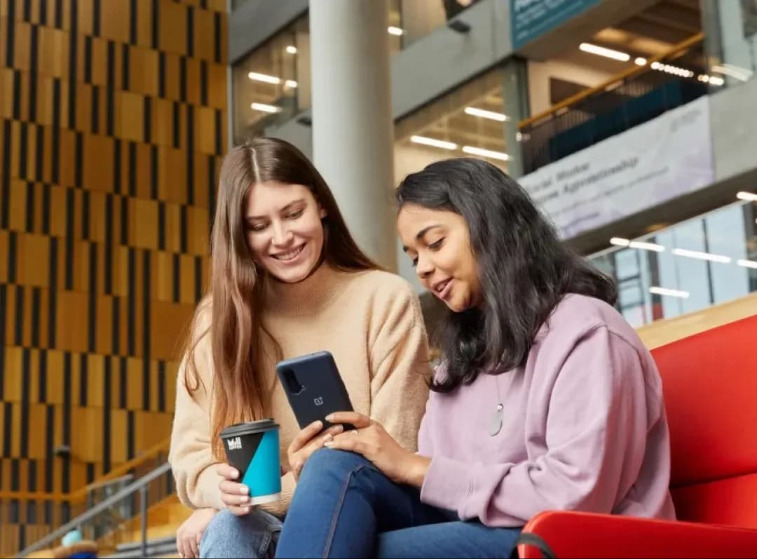 Manchester Metropolitan University, student chatting with friends